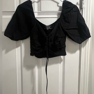 Cropped black tie shirt.